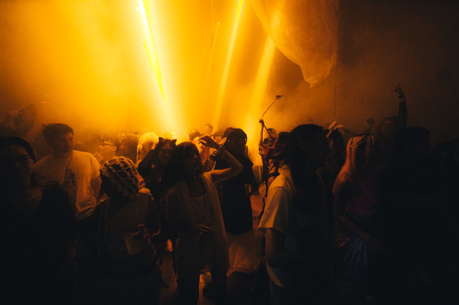 The crowd in warm yellow light, ambient and moody