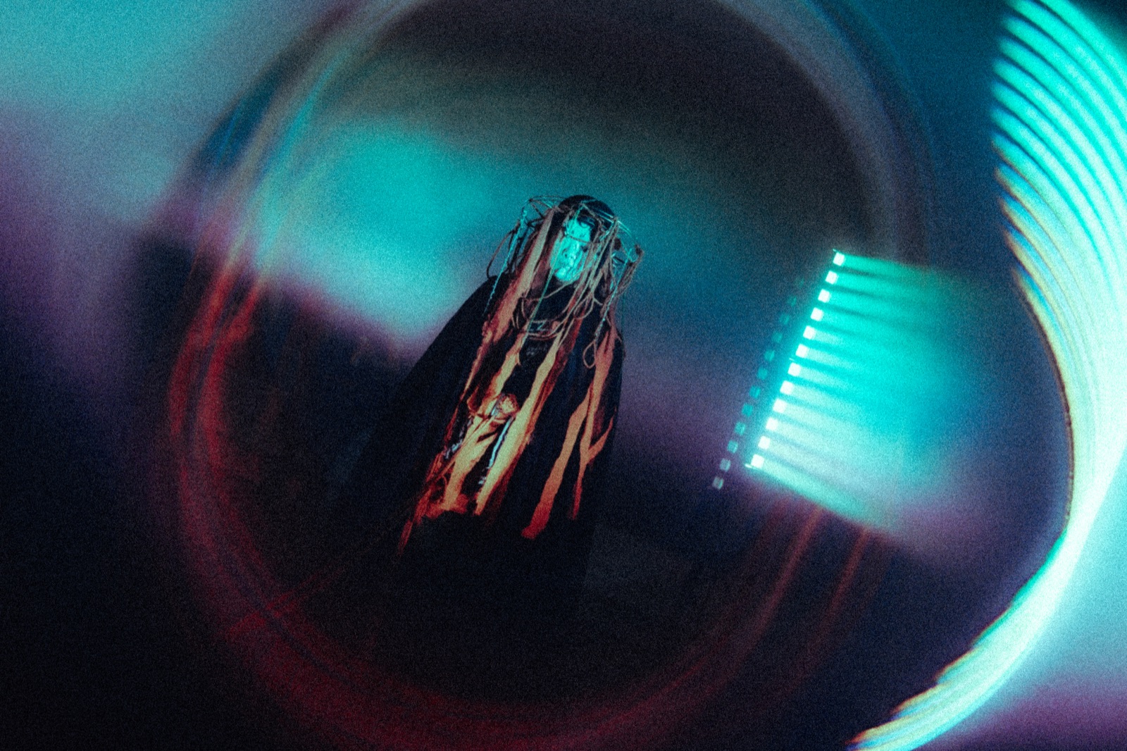 A performance artist in moody blue light
