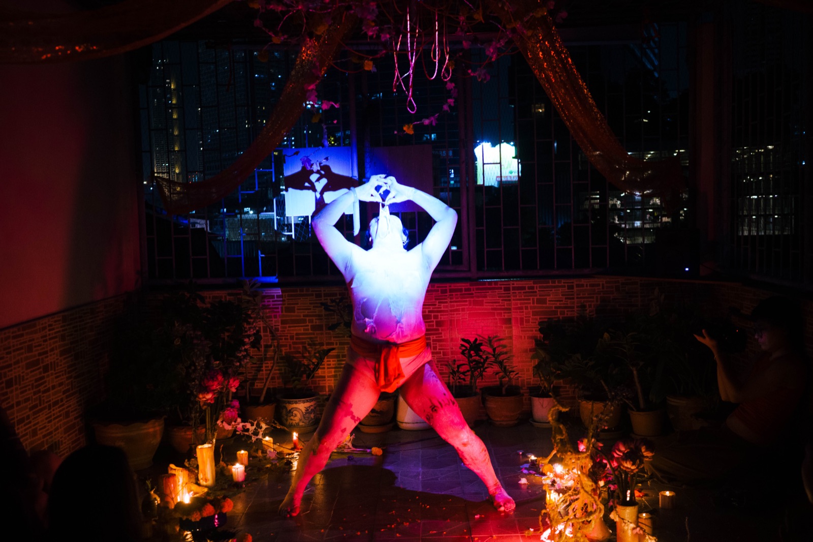 A performer under a blue spotlight