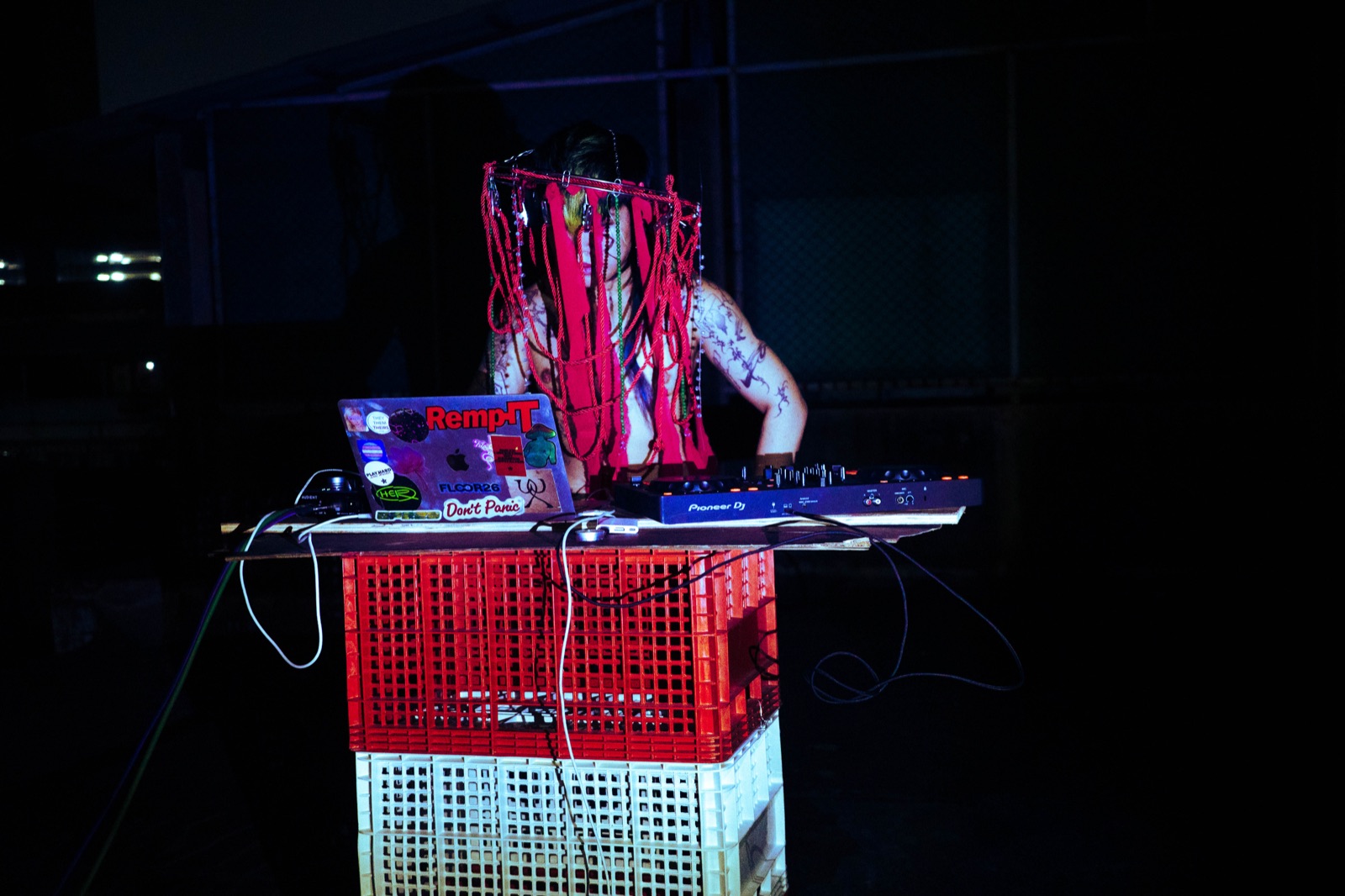Zenon DJing in a red headpiece