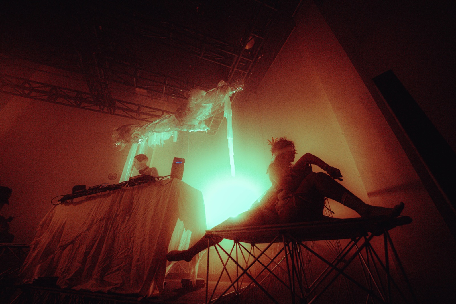 DJ and performance artists on stage in a dreamy haze